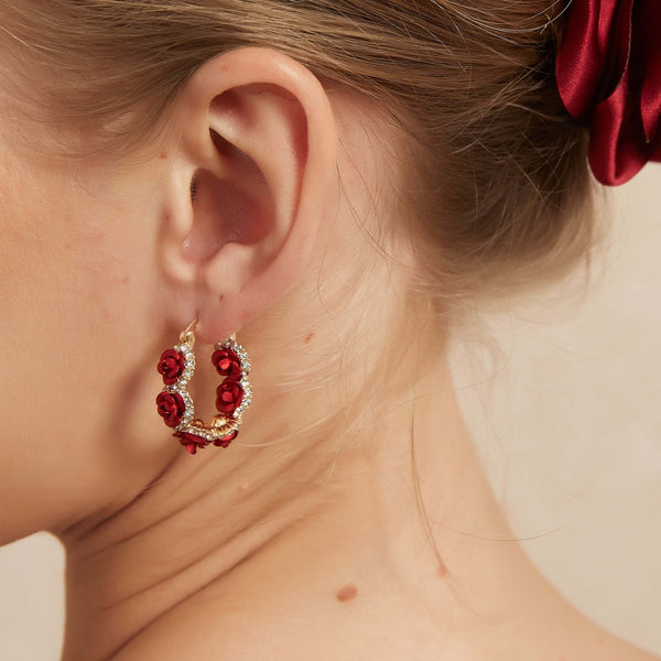 Bloom with elegance in our Rose Garden Hoop Earrings—a radiant golden hoop adorned with six delicate metal flowers, each shimmering with an array of CZ stones. Lightweight yet striking, these hoops capture the beauty of a blossoming garden in every twinkle.
