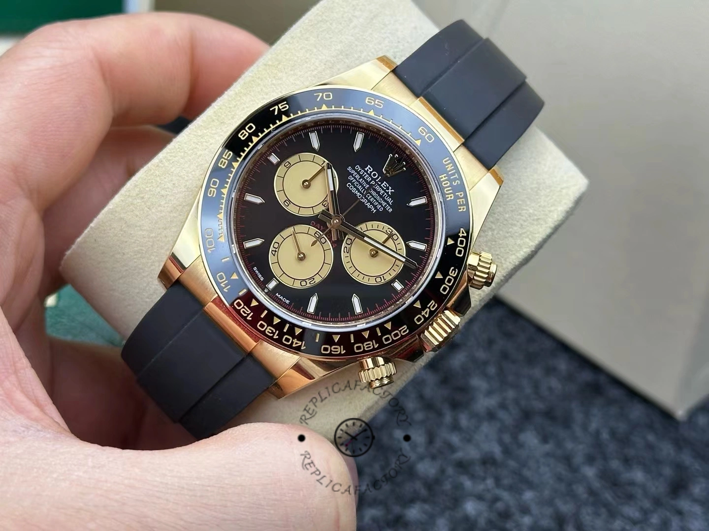 Angled handheld shot of Rolex Daytona 126518LN emphasizing gold case and Oysterflex strap.