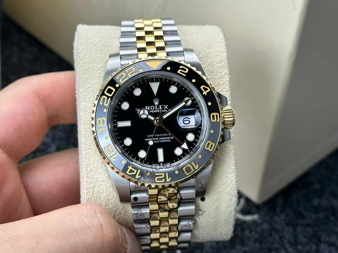 Real photo of Rolex GMT-Master II 126713GRNR-0001 showing black dial, gold bezel, and Jubilee bracelet.